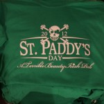 Green T-shirt with a white skull and crossbones design, screen printed text reading "2012 St. Paddy's Day, A Terrible Beauty Irish Pub"—perfect for celebrating St. Patrick's Day in style. Rain City West