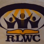 Logo with three stylized human figures under yellow rays, an open book below them, and the letters "RLWC" at the bottom—perfect for RLWC t-shirts or promotional materials. Rain City West