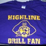 A purple T-shirt by Highline Gear featuring yellow "HIGHLINE DRILL FAN" text and an illustration of a pirate's head with an eyepatch and skull hat—perfect for fans of Team Highline. Rain City West