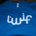Blue TWIF T-shirt featuring the word "wifi" in stylized white Arabic script across the chest—a unique addition to your World Is Fun T-shirts collection. Rain City West
