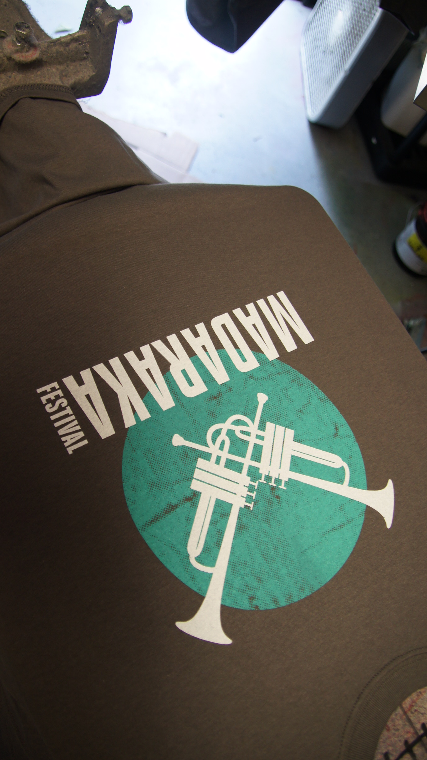 Screening printing the Madaraka Festival t-shirts. Here is one that is still on the press.