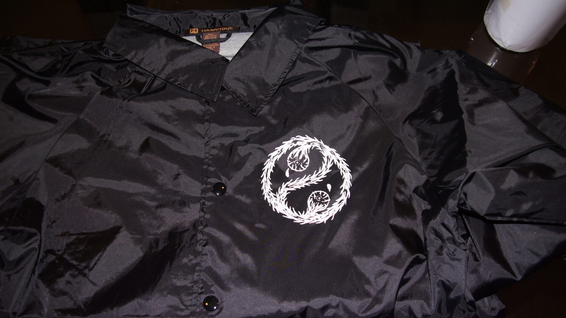 Left Chest screen print on coach jacket.