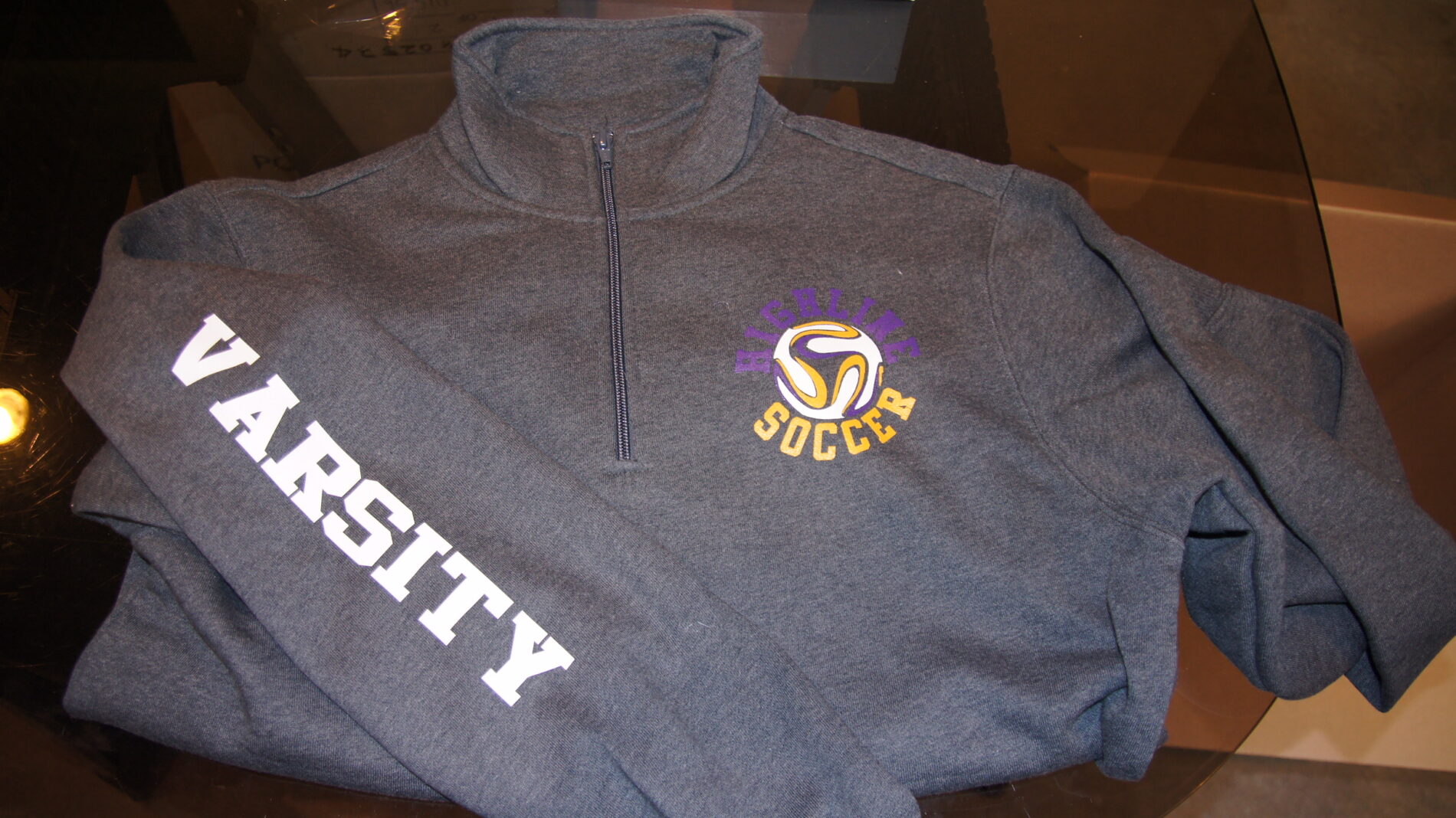 1/4 zip sweatshirt with screen printing on it.