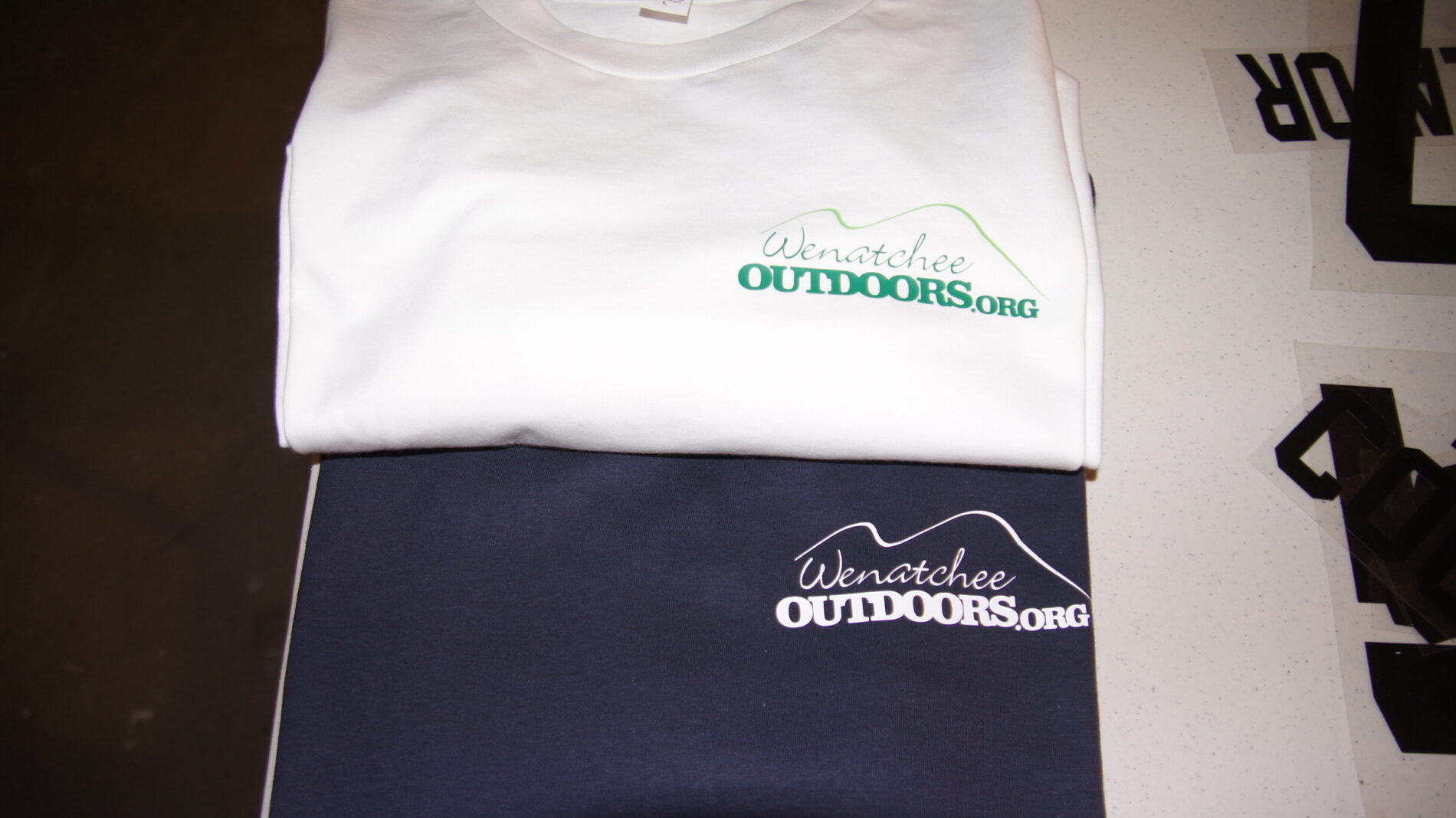 Showing two different color ways with green and white vinyl heat transfer.