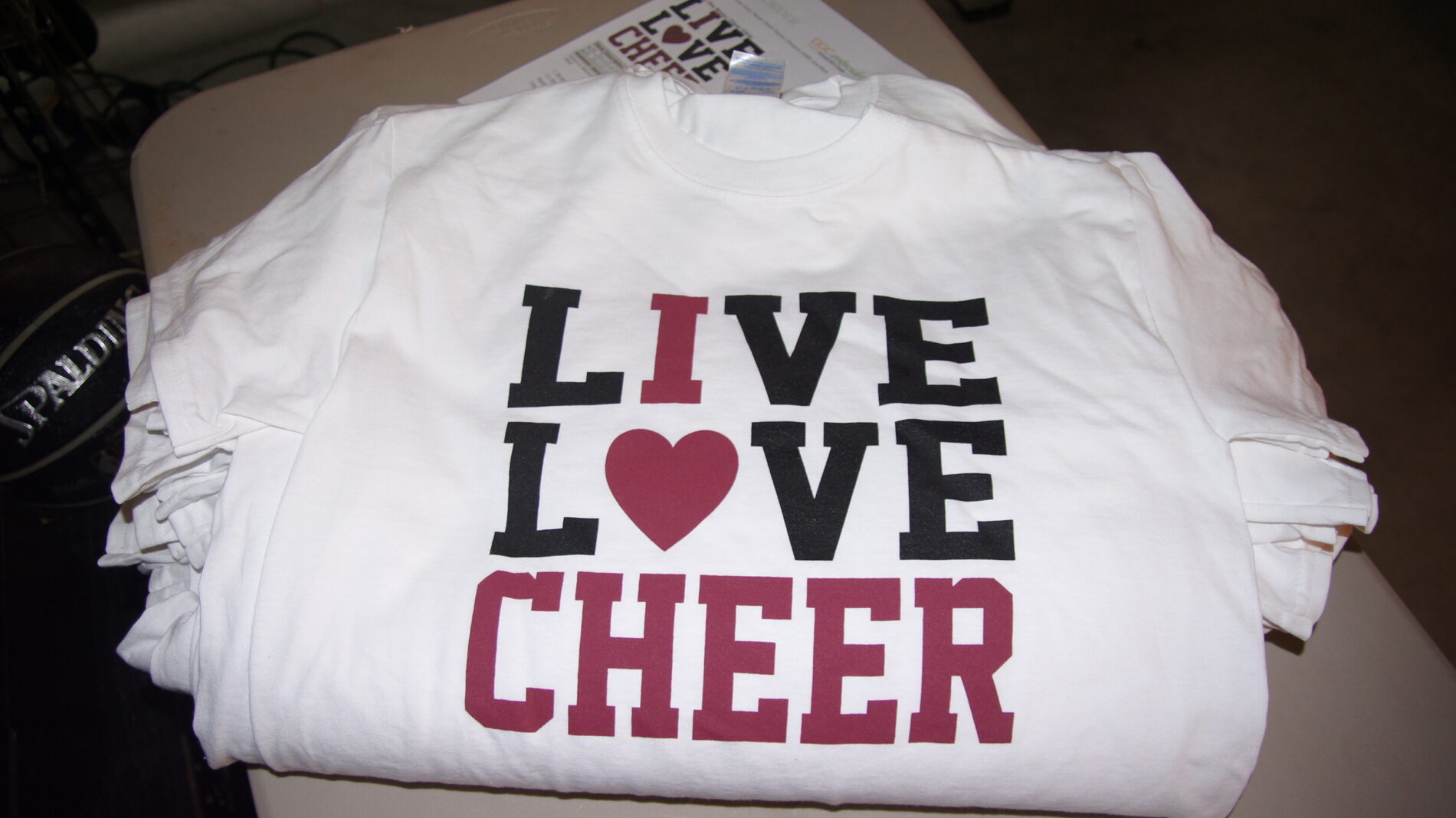 Live Love Cheer two color screen printed t-shirts.