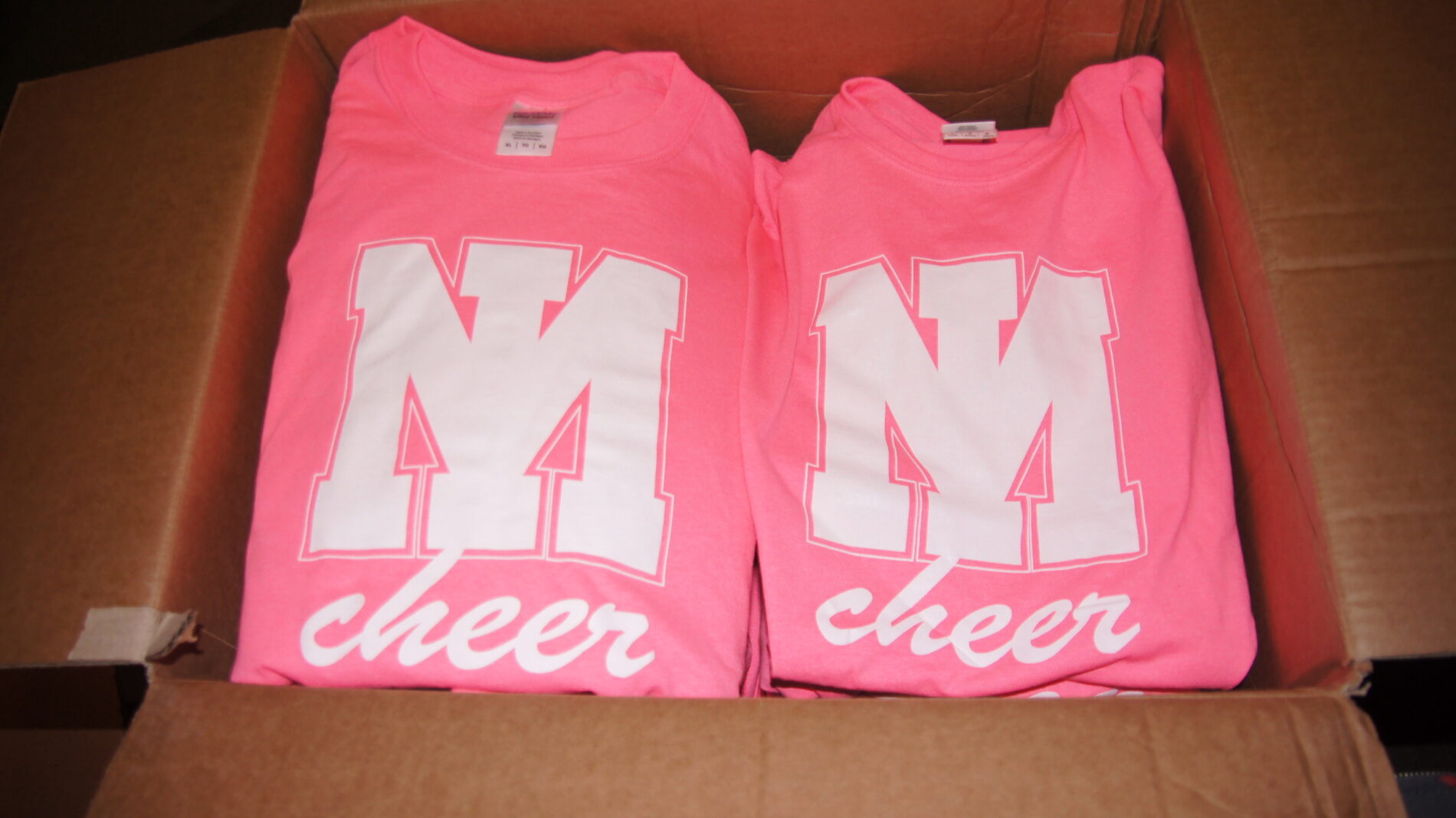 Pink Mercer Island Cheer t-shirts screen printed with 1-color image.