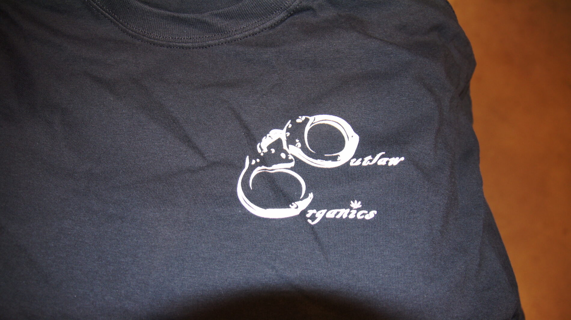 Love the Outlaw Organics logo screen printed on black t-shirts.