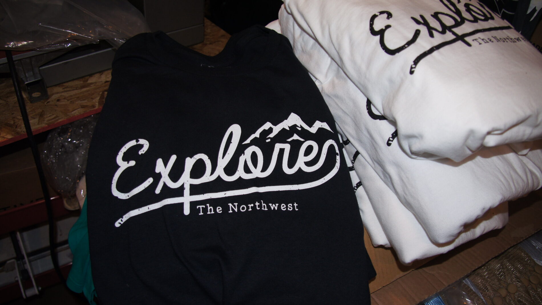 Explores the Northwest screen printed on black and white t-shirts.