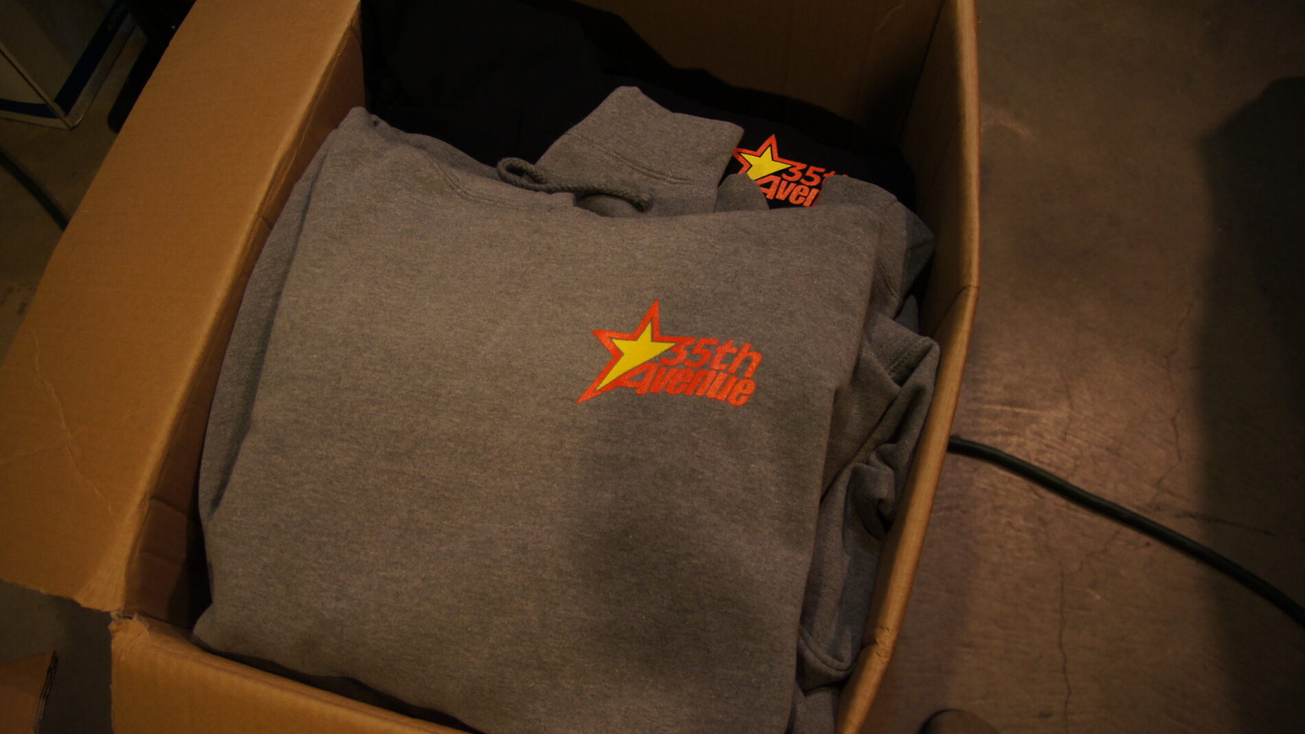 2-color left chest screen printed on a hooded sweatshirt for 35th Avenue. 